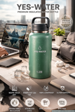 Green insulated water bottle with 'YES-WATER' branding on a desk with laptop and accessories.