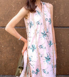 Woman wearing a floral dress with a textured wall background