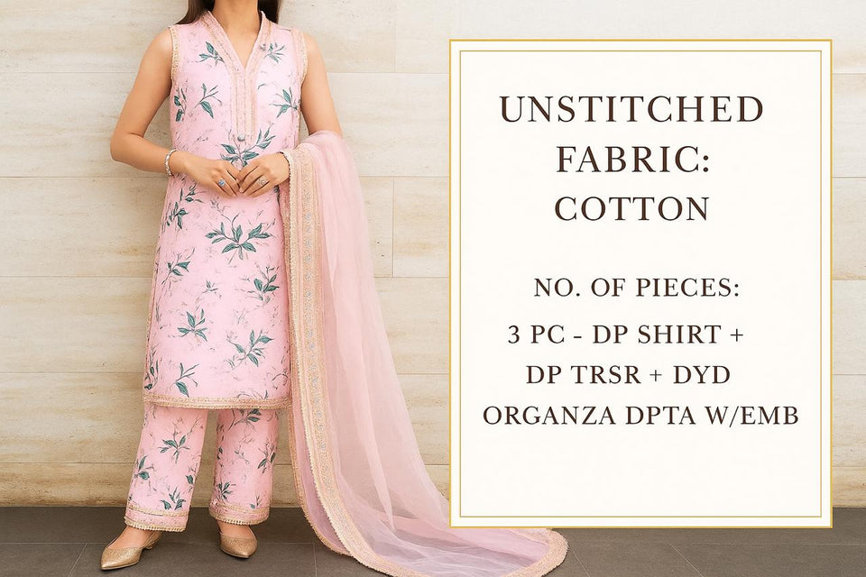 Unstitched fabric set with a pink shirt, pants, and dupatta on a wooden background.